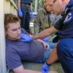 First responder providing emergency medical care to an injured individual during a hands-on training session in Ontario's First Responder and CPR course